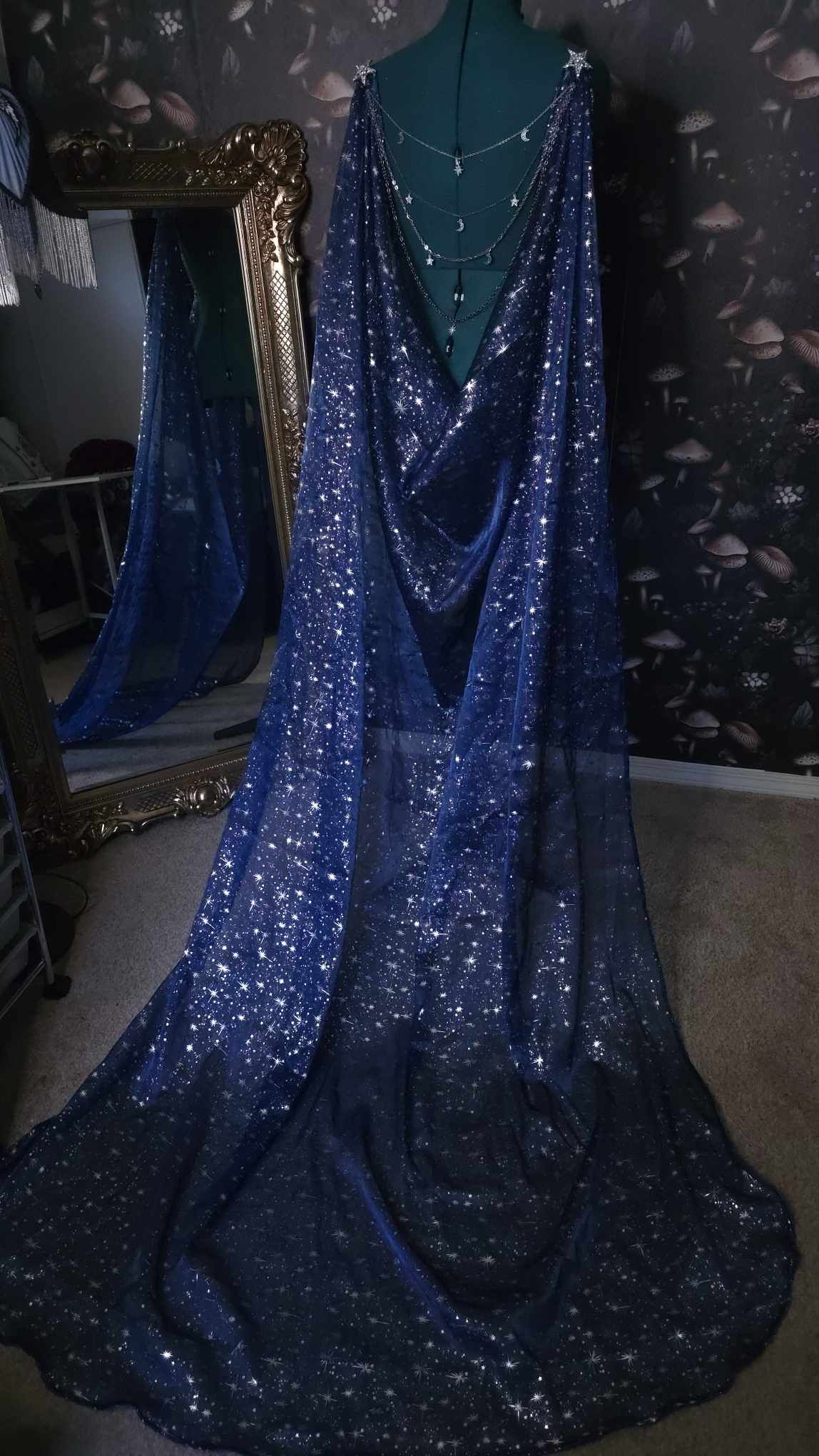 Beautiful celestial cape with a jewelry statement back piece.